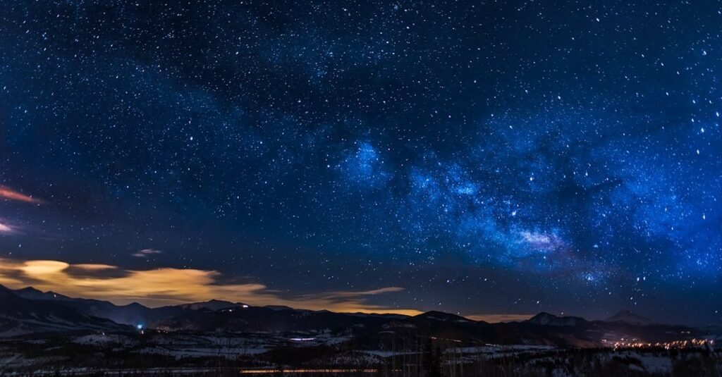 A breathtaking view of the Milky Way galaxy illuminating the night sky over mountains.